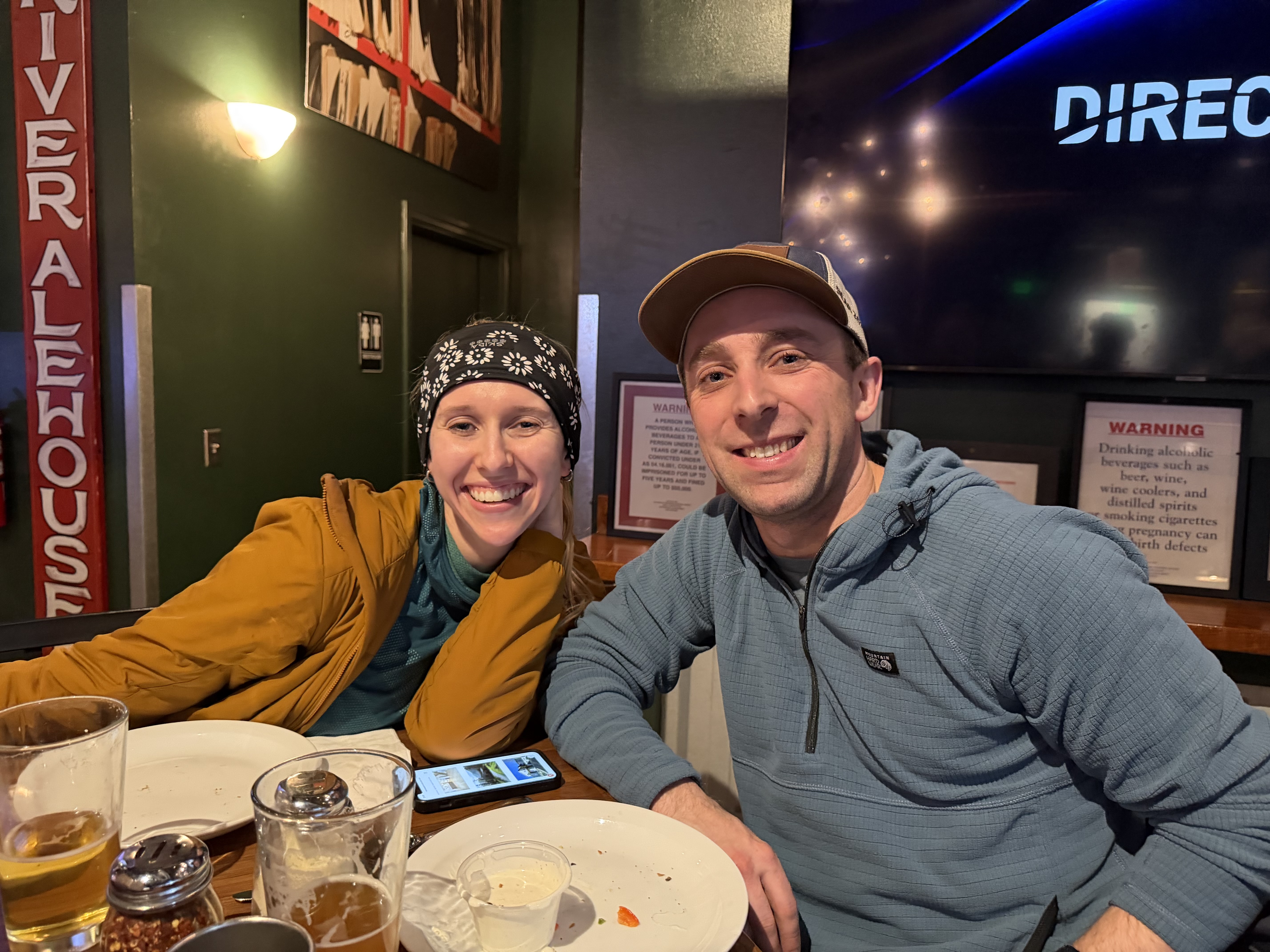Friends smiling inside Eagle River Alehouse